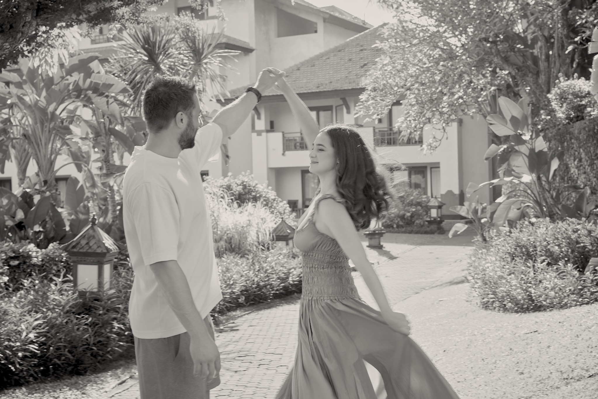 Taylor and Peter dancing together in a garden
